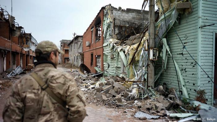 A marine patrols in the remains of Shirokino