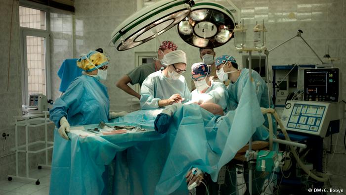 Volunteer Canadian doctors operate on a wounded man